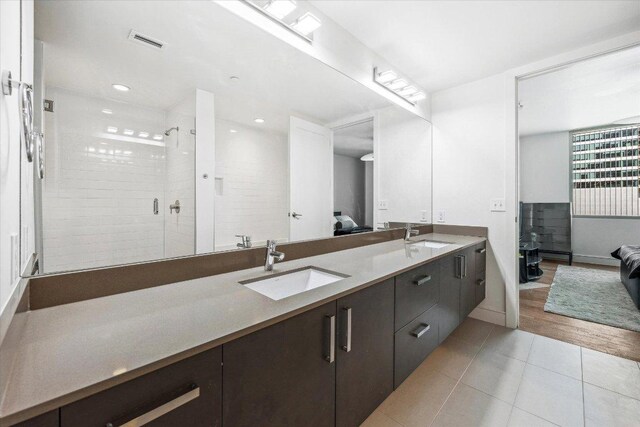 222 W Ave Unit 1213, Austin, TX 78701 - full bath featuring ensuite bathroom, double vanity, a stall shower, tile patterned floors, and recessed lighting