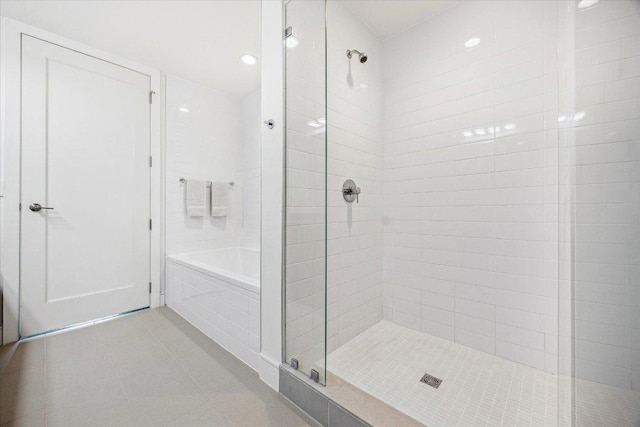 222 W Ave Unit 1213, Austin, TX 78701 - bathroom featuring tiled shower, tile patterned floors, and tiled tub