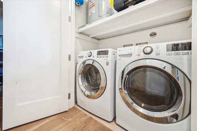 222 W Ave Unit 1213, Austin, TX 78701 - laundry area featuring washing machine and dryer and light wood-style flooring