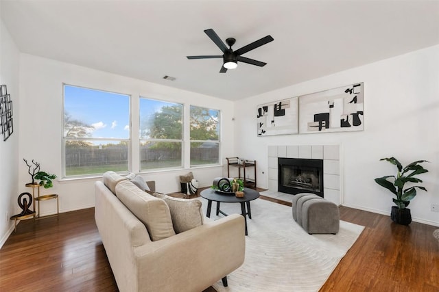 2126 Simbrah Dr, Cedar Park, TX 78613 - living area featuring ceiling fan, wood finished floors, a tiled fireplace, and baseboards