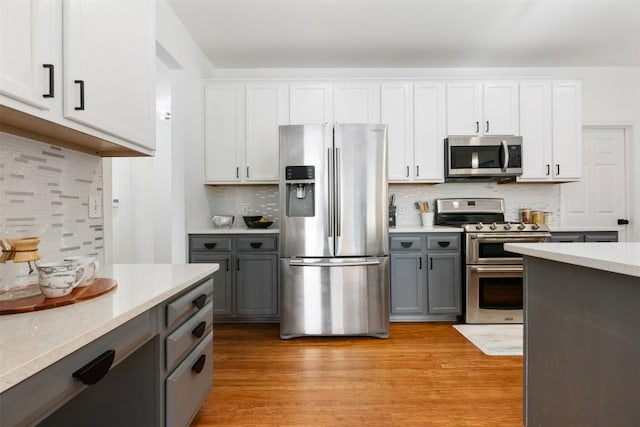 2126 Simbrah Dr, Cedar Park, TX 78613 - kitchen with appliances with stainless steel finishes, gray cabinetry, and tasteful backsplash