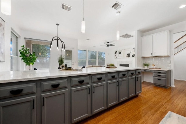 2126 Simbrah Dr, Cedar Park, TX 78613 - kitchen featuring gray cabinets, white cabinetry, and tasteful backsplash