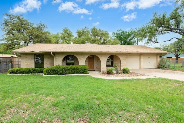1304 Knollwood Cv, Round Rock, TX 78681 - view of front of house featuring a garage, concrete driveway, a shingled roof, and brick siding