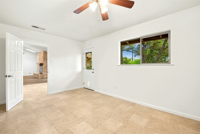 1304 Knollwood Cv, Round Rock, TX 78681 - unfurnished room with baseboards, a fireplace, and a ceiling fan