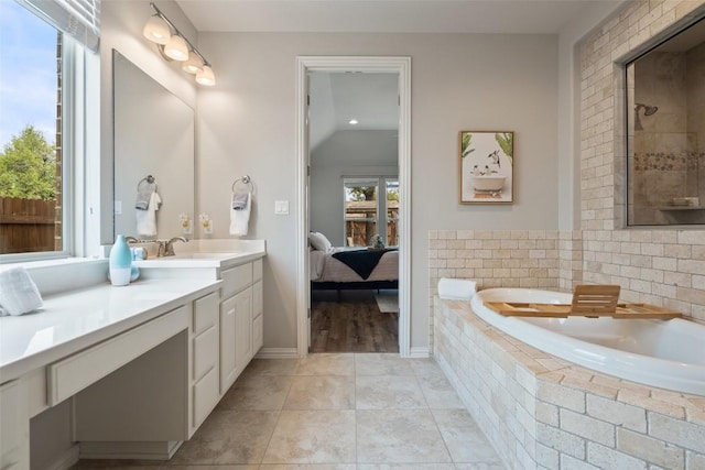 5621 Cypress Ranch Blvd, Spicewood, TX 78669 - ensuite bathroom with a bath, vanity, tile patterned flooring, lofted ceiling, and tiled shower