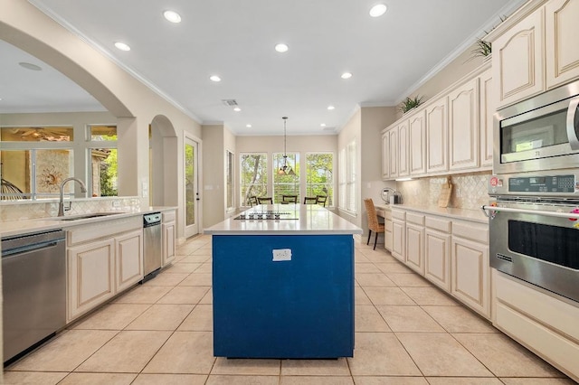 4321 Lakeway Blvd, Austin, TX 78734 - kitchen featuring appliances with stainless steel finishes, a center island, decorative backsplash, recessed lighting, and ornamental molding