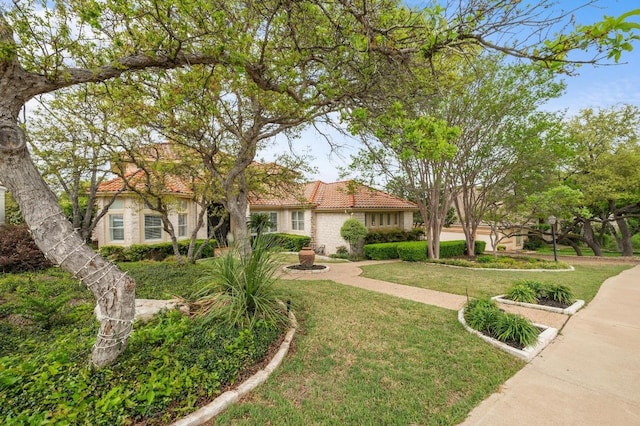 4321 Lakeway Blvd, Austin, TX 78734 - view of front of house with a tile roof, a front lawn, and stucco siding