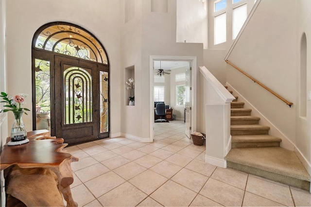 4321 Lakeway Blvd, Austin, TX 78734 - entrance foyer featuring light tile patterned flooring, stairs, a towering ceiling, and ceiling fan