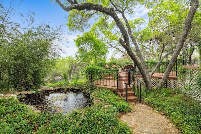 4321 Lakeway Blvd, Austin, TX 78734 - view of yard featuring a deck, a small pond, and stairway
