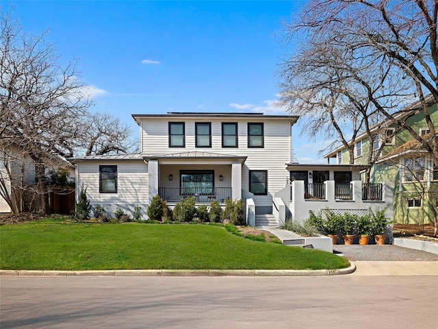 1004 Maufrais St, Austin, TX 78703 - view of front facade featuring a standing seam roof, a metal roof, a front yard, a sunroom, and covered porch