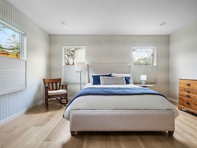 1004 Maufrais St, Austin, TX 78703 - bedroom with wallpapered walls, light wood-style floors, and multiple windows