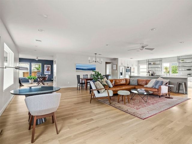 1004 Maufrais St, Austin, TX 78703 - living room featuring light wood-style floors, a ceiling fan, recessed lighting, and a chandelier