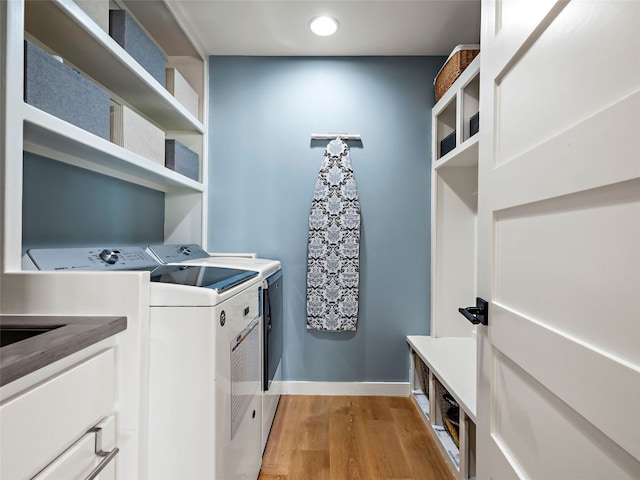 1004 Maufrais St, Austin, TX 78703 - laundry area featuring cabinet space, washer and clothes dryer, light wood-style floors, and recessed lighting