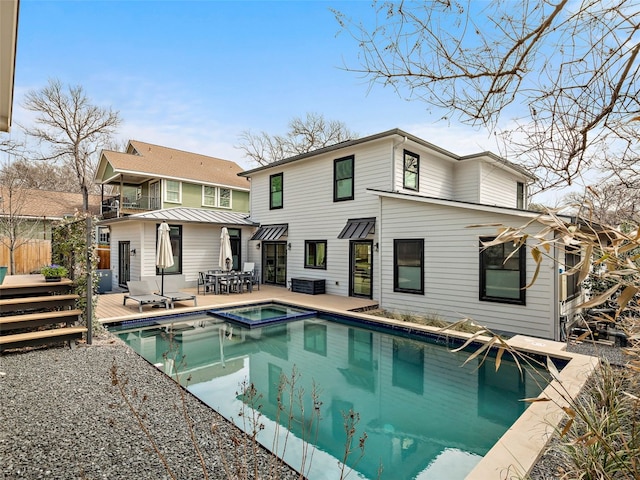 1004 Maufrais St, Austin, TX 78703 - rear view of property featuring a wooden deck and a pool with connected hot tub