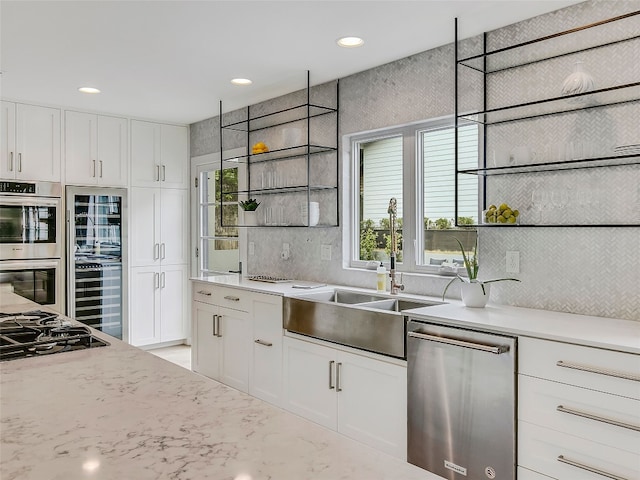1004 Maufrais St, Austin, TX 78703 - kitchen with appliances with stainless steel finishes, white cabinets, beverage cooler, recessed lighting, and backsplash