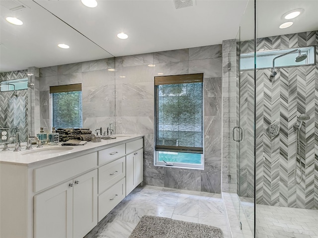 1004 Maufrais St, Austin, TX 78703 - bathroom featuring tile walls, double vanity, healthy amount of natural light, a stall shower, and marble finish floors