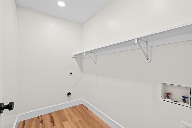 6303 Bexton Cir, Austin, TX 78745 - laundry area with hookup for a washing machine, light wood-style flooring, hookup for an electric dryer, and recessed lighting