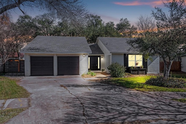 6303 Bexton Cir, Austin, TX 78745 - view of front of property featuring an attached garage, brick siding, concrete driveway, and a shingled roof