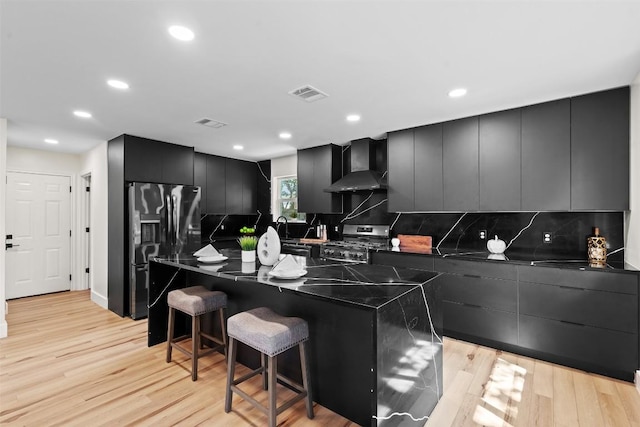 6303 Bexton Cir, Austin, TX 78745 - kitchen with wall chimney exhaust hood, refrigerator with ice dispenser, stainless steel gas range, modern cabinets, and recessed lighting