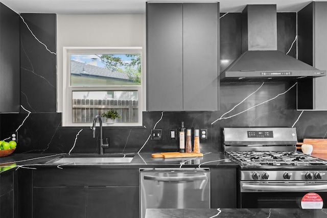 6303 Bexton Cir, Austin, TX 78745 - kitchen with wall chimney range hood, stainless steel appliances, modern cabinets, dark countertops, and decorative backsplash