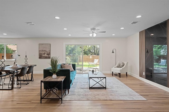 6303 Bexton Cir, Austin, TX 78745 - living room featuring a ceiling fan, recessed lighting, plenty of natural light, light wood finished floors, and baseboards