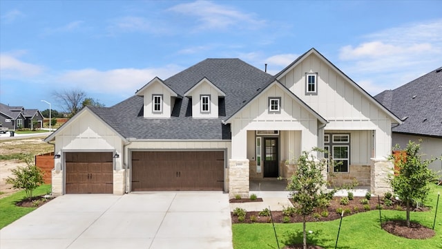 2301 Tobiano Trce, Georgetown, TX 78633 - modern farmhouse featuring roof with shingles, board and batten siding, a garage, and stone siding