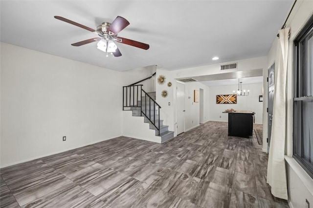 906 E Village Ln, Austin, TX 78758 - unfurnished living room featuring stairway, ceiling fan, a chandelier, and recessed lighting