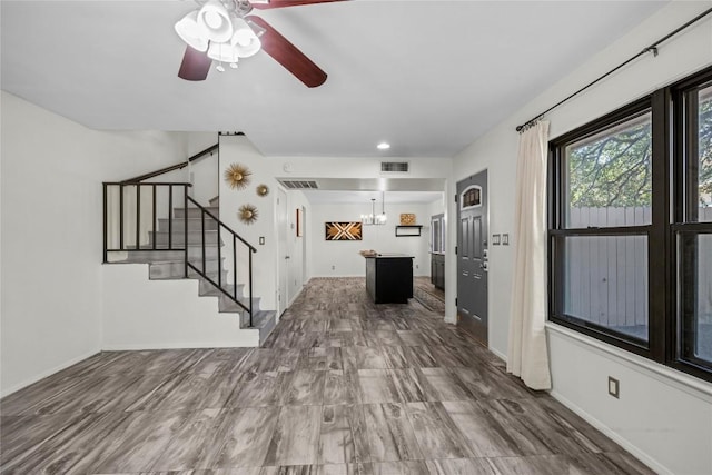 906 E Village Ln, Austin, TX 78758 - unfurnished living room featuring stairs, a chandelier, a ceiling fan, and recessed lighting