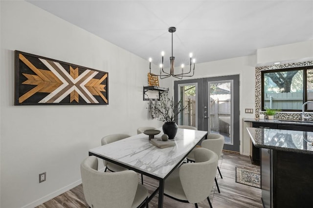 906 E Village Ln, Austin, TX 78758 - dining room featuring a chandelier and wood finished floors