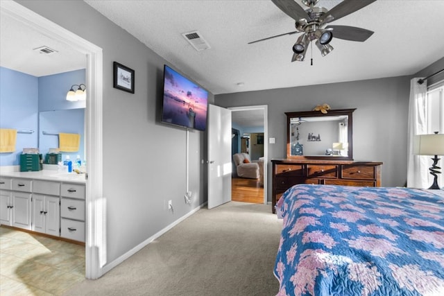 bedroom with a textured ceiling, baseboards, light carpet, and visible vents