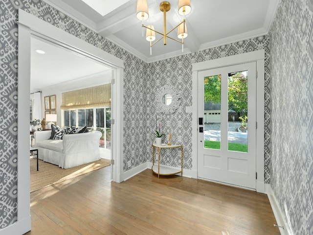 2610 Jefferson St, Austin, TX 78703 - foyer entrance with crown molding, wallpapered walls, a chandelier, and wood-type flooring