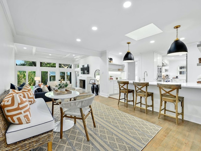 2610 Jefferson St, Austin, TX 78703 - dining space featuring a skylight, crown molding, recessed lighting, and light wood finished floors