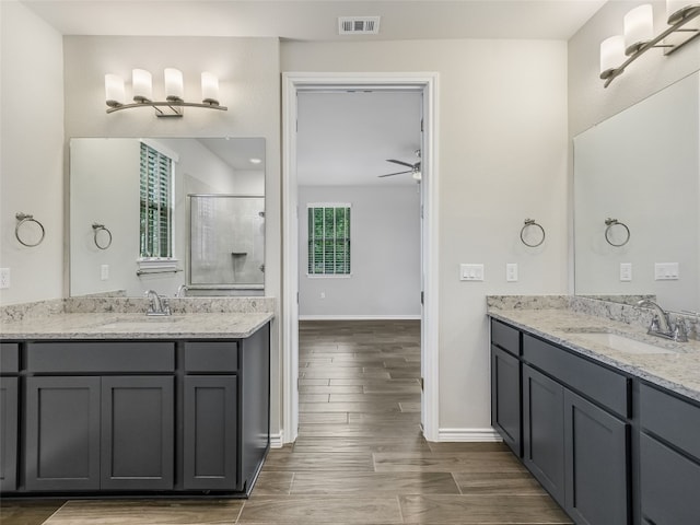 full bath featuring baseboards, a sink, visible vents, and a stall shower