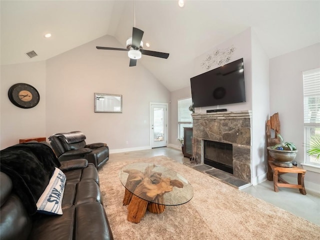 carpeted living area featuring a fireplace, visible vents, a ceiling fan, and a healthy amount of sunlight