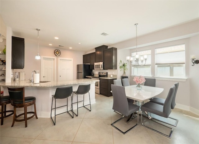 dining room with a chandelier, recessed lighting, light tile patterned floors, and baseboards