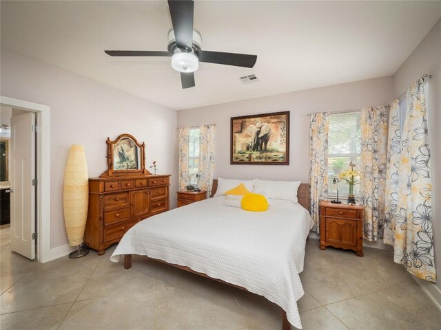 17504 Village Dr, Dripping Springs, TX 78620 - bedroom with multiple windows, a ceiling fan, and light tile patterned floors