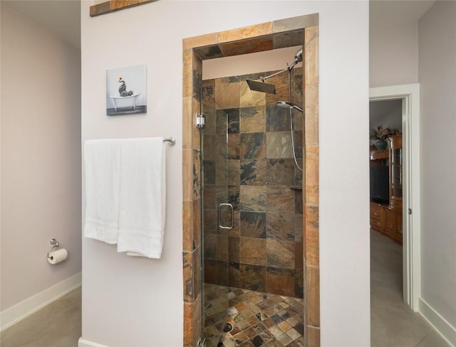 bathroom featuring a stall shower and baseboards