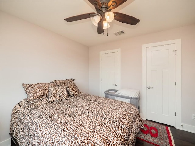 bedroom with visible vents, baseboards, and ceiling fan