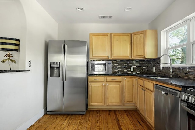 512 Bouldin Ave, Austin, TX 78704 - kitchen featuring appliances with stainless steel finishes, backsplash, dark wood-style flooring, and recessed lighting