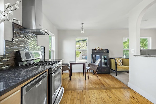 512 Bouldin Ave, Austin, TX 78704 - kitchen featuring appliances with stainless steel finishes, extractor fan, backsplash, and light wood-type flooring