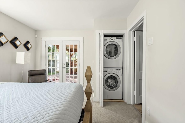 512 Bouldin Ave, Austin, TX 78704 - carpeted bedroom featuring stacked washing machine and dryer, french doors, and access to exterior