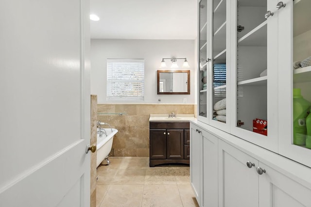 512 Bouldin Ave, Austin, TX 78704 - full bath featuring tile patterned flooring, a freestanding tub, vanity, tile walls, and wainscoting