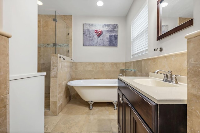 512 Bouldin Ave, Austin, TX 78704 - bathroom featuring tile walls, a freestanding tub, walk in shower, vanity, and wainscoting