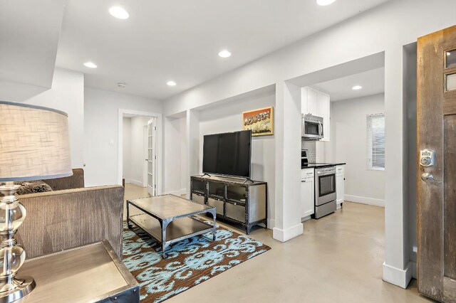 512 Bouldin Ave, Austin, TX 78704 - living room featuring finished concrete floors and recessed lighting