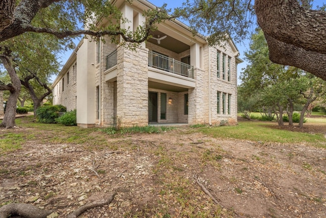 2305 Barton Creek Blvd Unit 36, Austin, TX 78735 - rear view of house featuring a balcony and stone siding