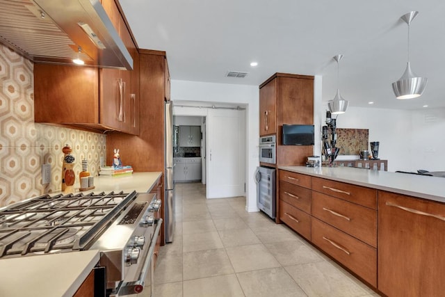402 Eagle, Lakeway, TX 78734 - kitchen featuring light countertops, visible vents, wine cooler, stainless steel appliances, and range hood
