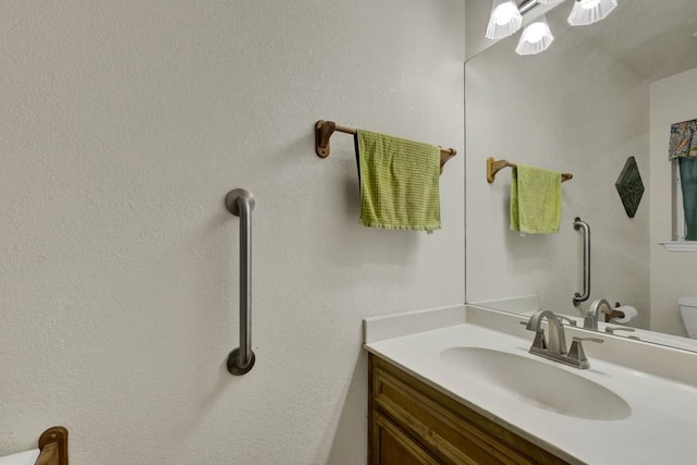 bathroom featuring toilet and vanity
