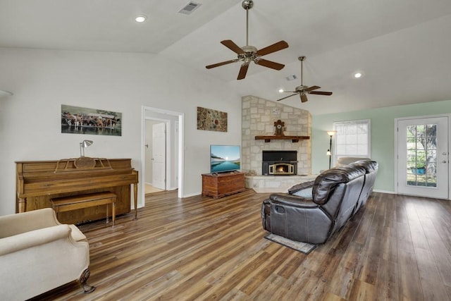 living area featuring lofted ceiling, visible vents, ceiling fan, and wood finished floors