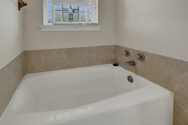 bathroom with a garden tub