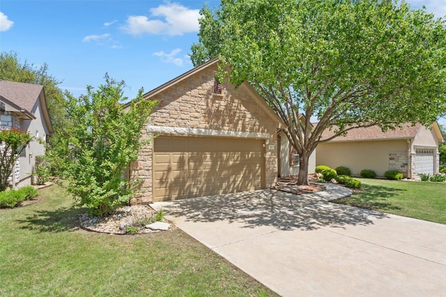 311 Dove Hollow Trl, Georgetown, TX 78633 - view of front of house featuring stone siding, an attached garage, concrete driveway, a front lawn, and stucco siding